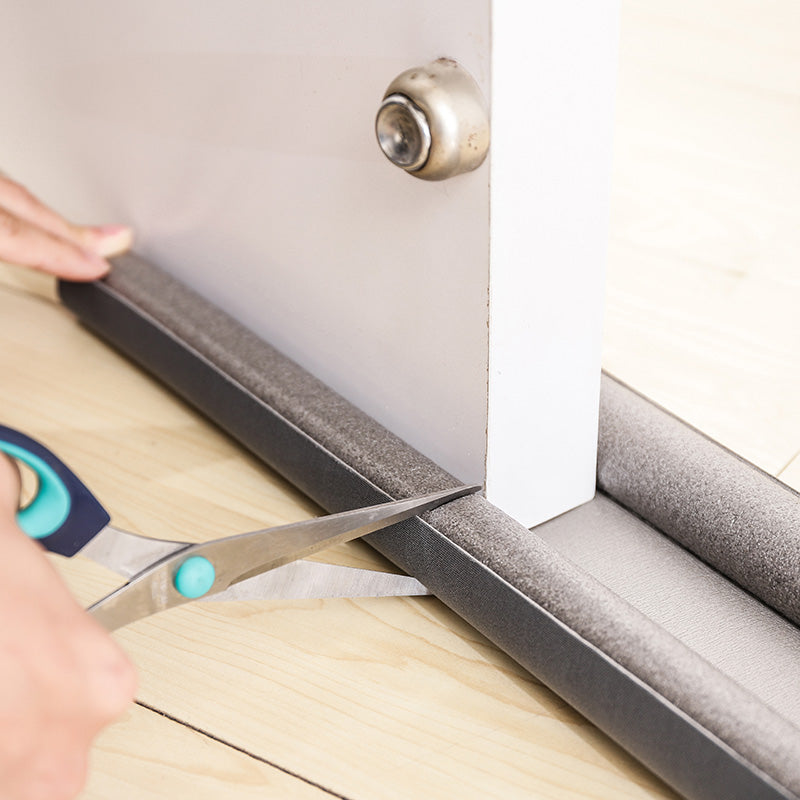 Twin draught excluder fitted under a door