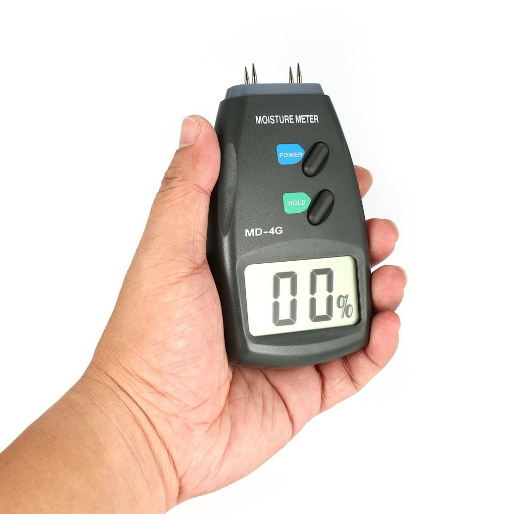 Moisture meter held in hand