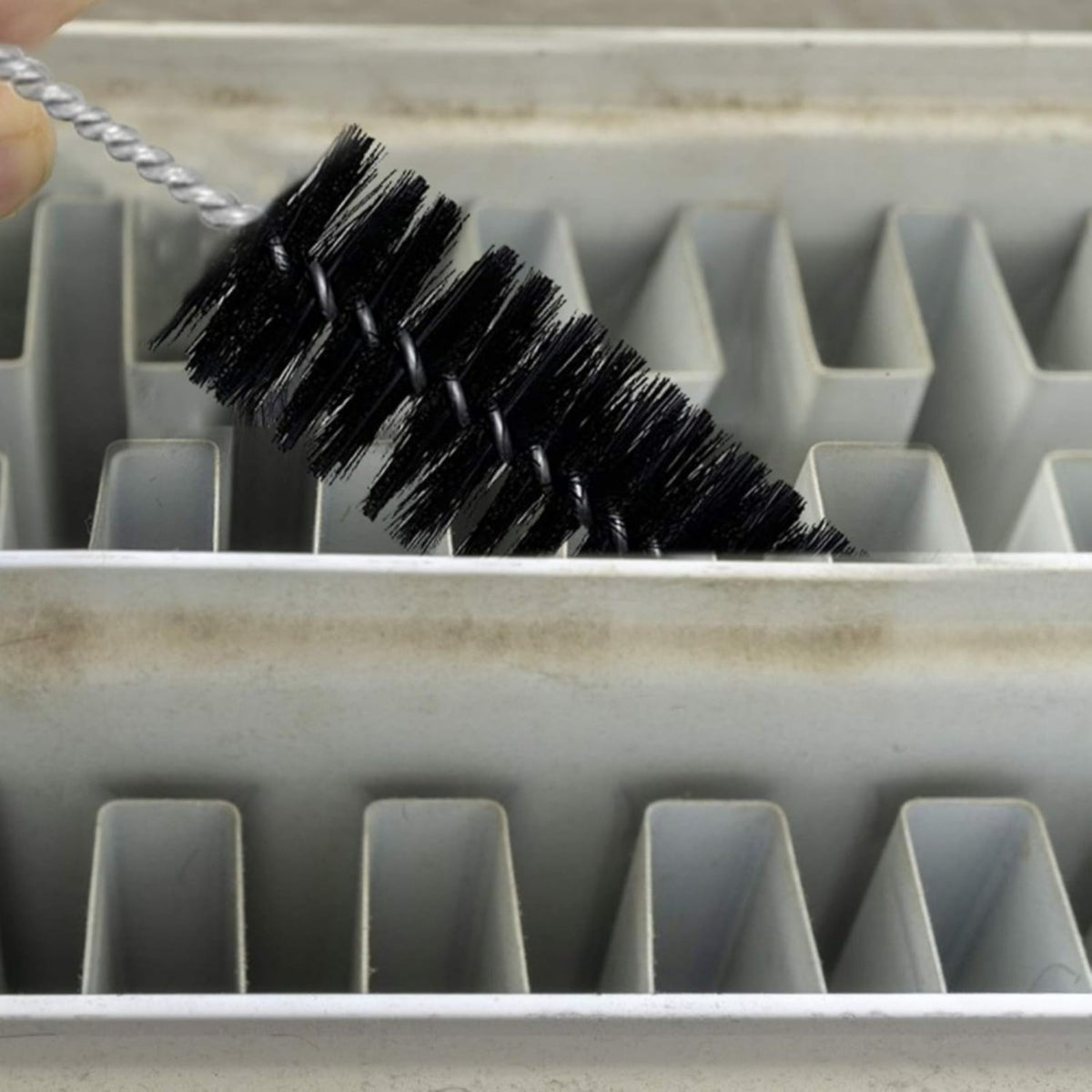 Brush reaching between radiator fins
