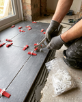 Tile levelling clips and wedges on a floor being tiled