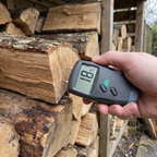 Moisture meter checking firewood is seasoned